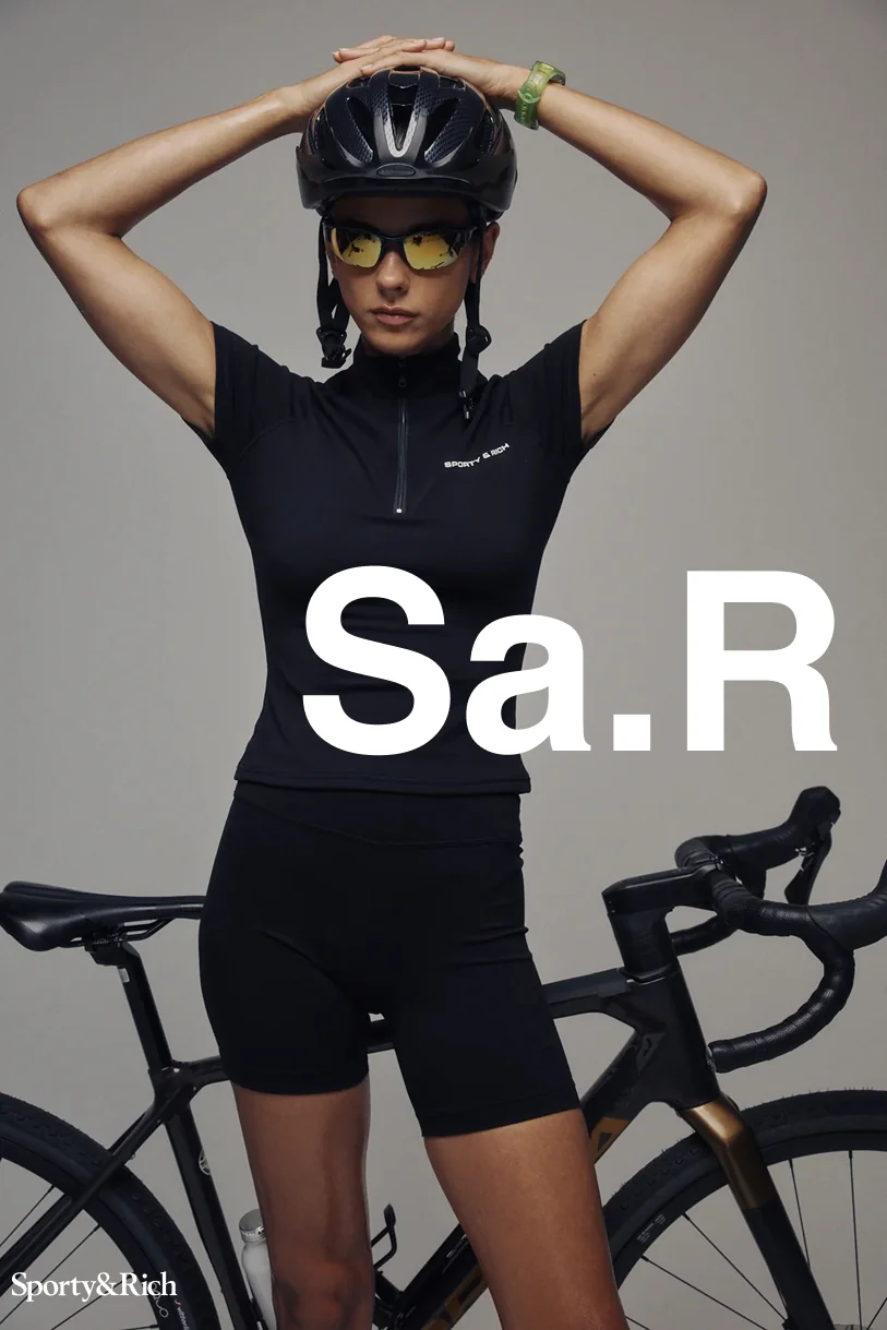 Sporty&Rich — Cyclist with arms raised and white Sa.R typography